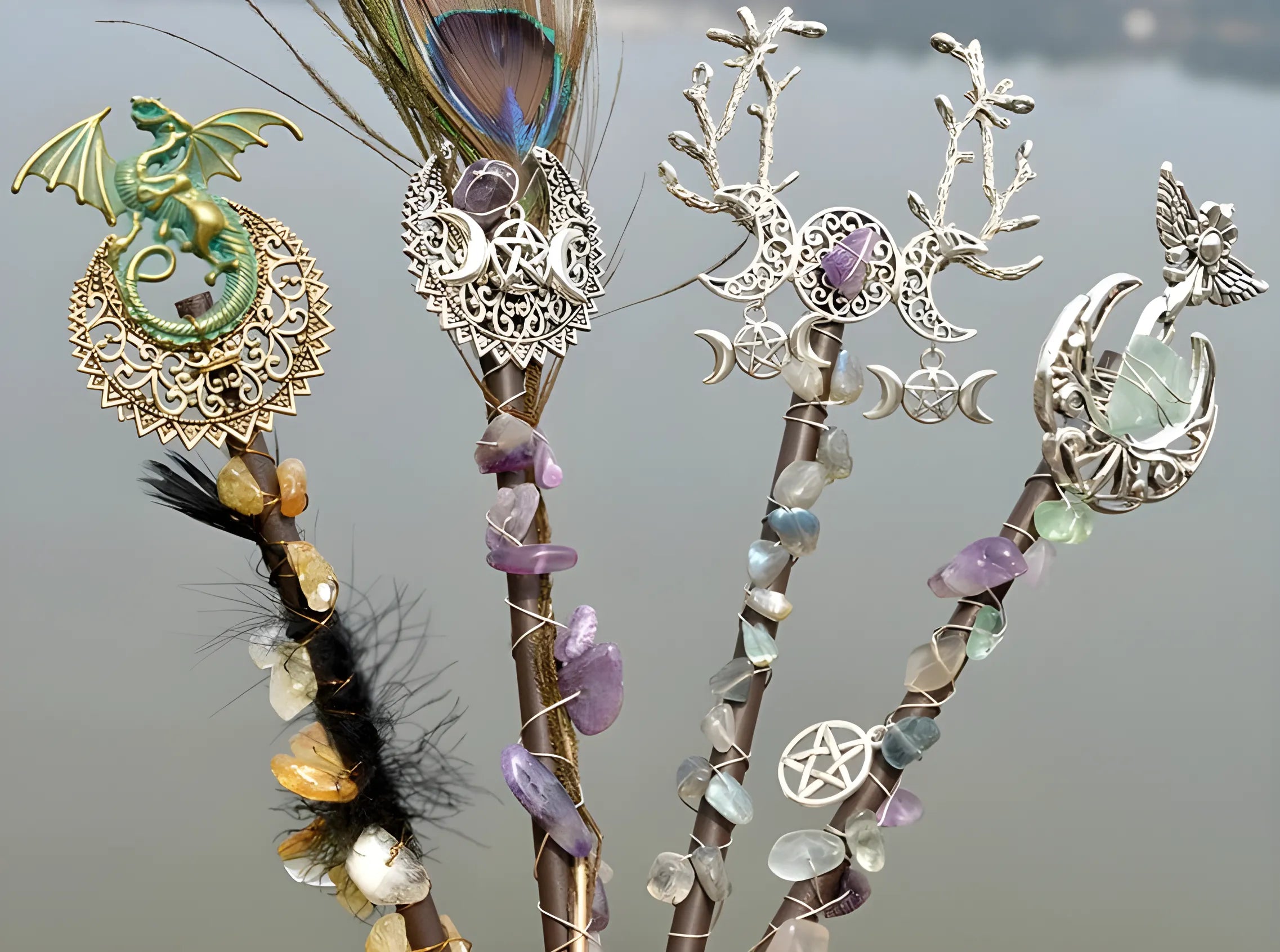 Decorative Amethyst Witch Crystal Wands with crystals, feathers, and metalwork designs.